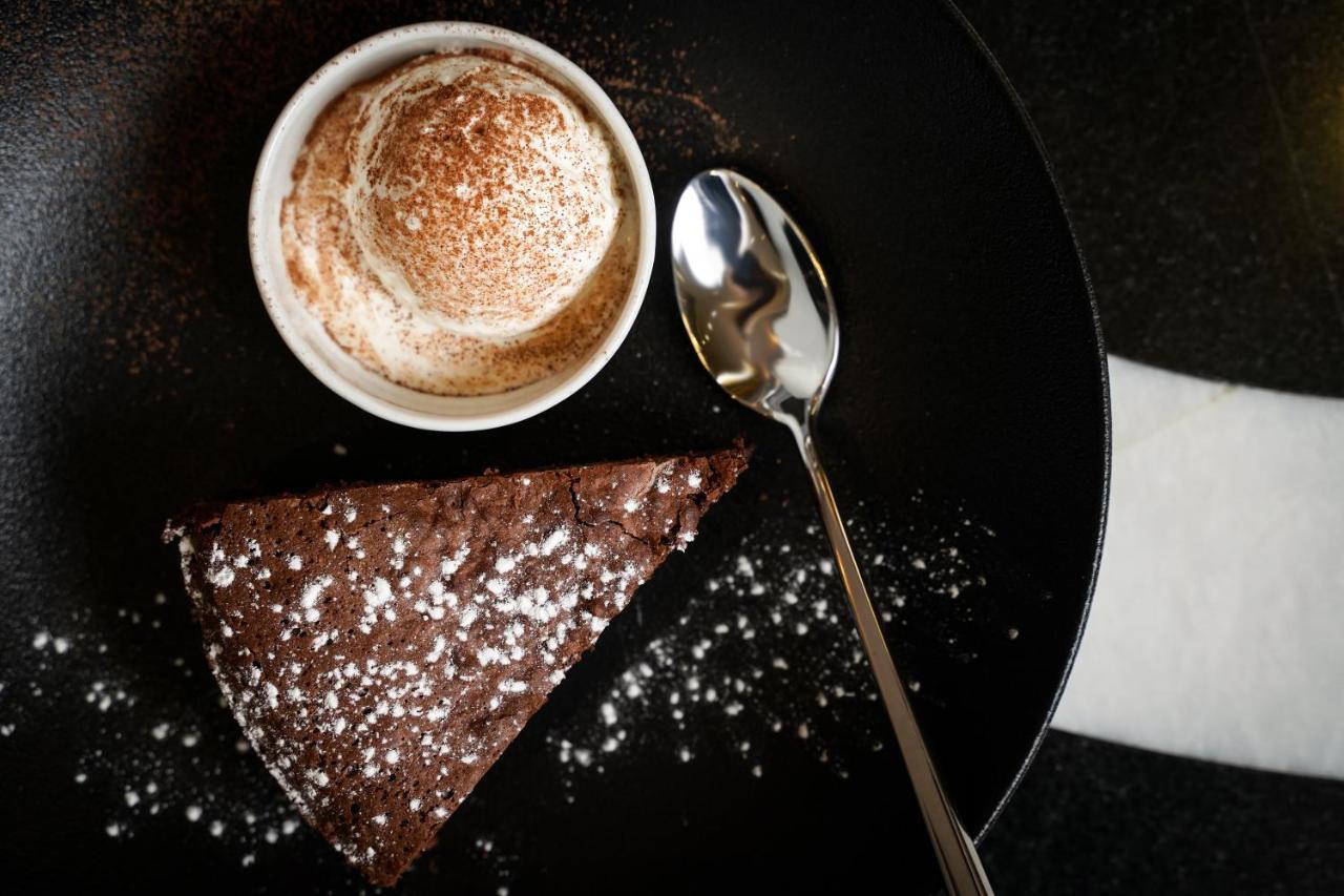 Ambiance Boutique Art Hotel 라호르 외부 사진 A chocolate cake with a cup of coffee